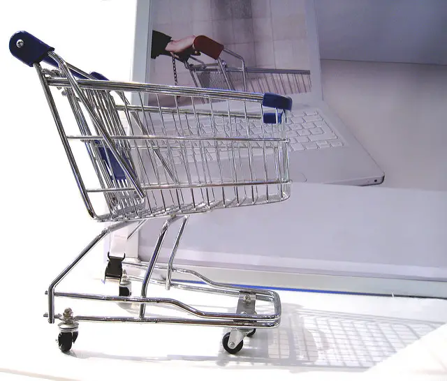A shopping trolley with a laptop as example of online shopping.