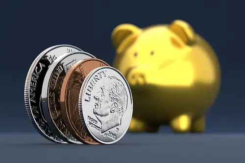 Coins with a gold piggy bank as an example of top up Manulife PRS online.