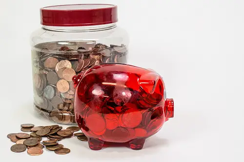 Coins in a red piggy bank for emergency account