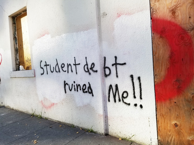 Text on the wall with words student debt ruined me.