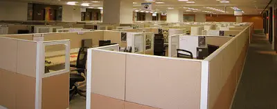 Light pink cubicles in a huge office.