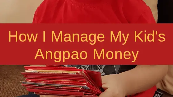 A kid wearing red shirt holding a bunch of  angpao money.