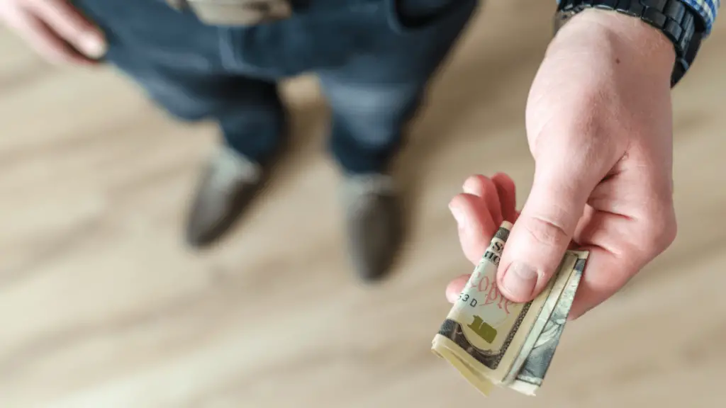 a man holding cash as an act of money lending