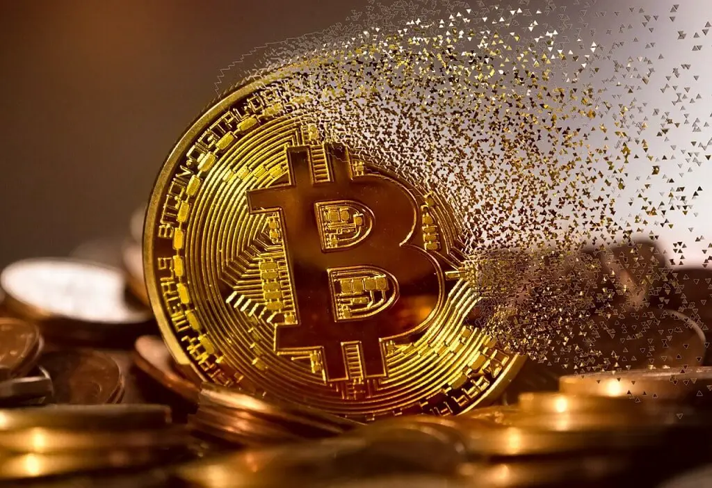 Bitcoin coin dissolving into pixels as sign of the risks investing in Bitcoin