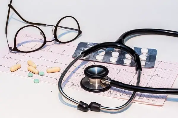 Things related to medical insurance such as ECG, stethoscope and medicine.