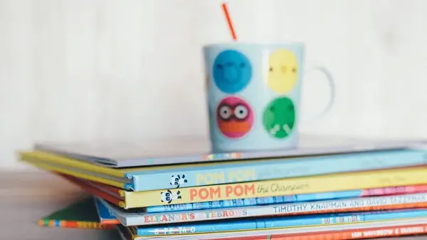 A stack of toddler books as part of baby first-year expenses
